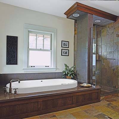 A bathroom with a soaking tub and glass shower