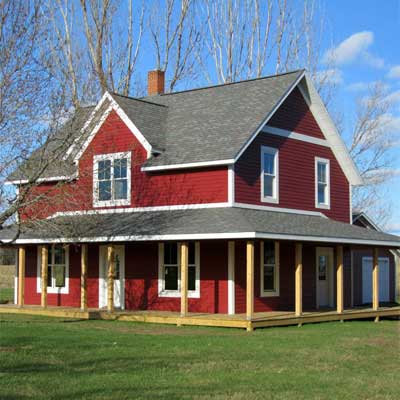 A remodeled house with red siding and white trim