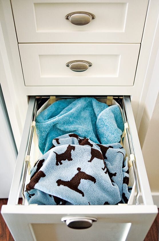 Pull-out canvas hamper concealed in drawer below counter.