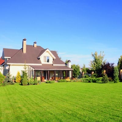 Large home with well-manicured grass lawn.