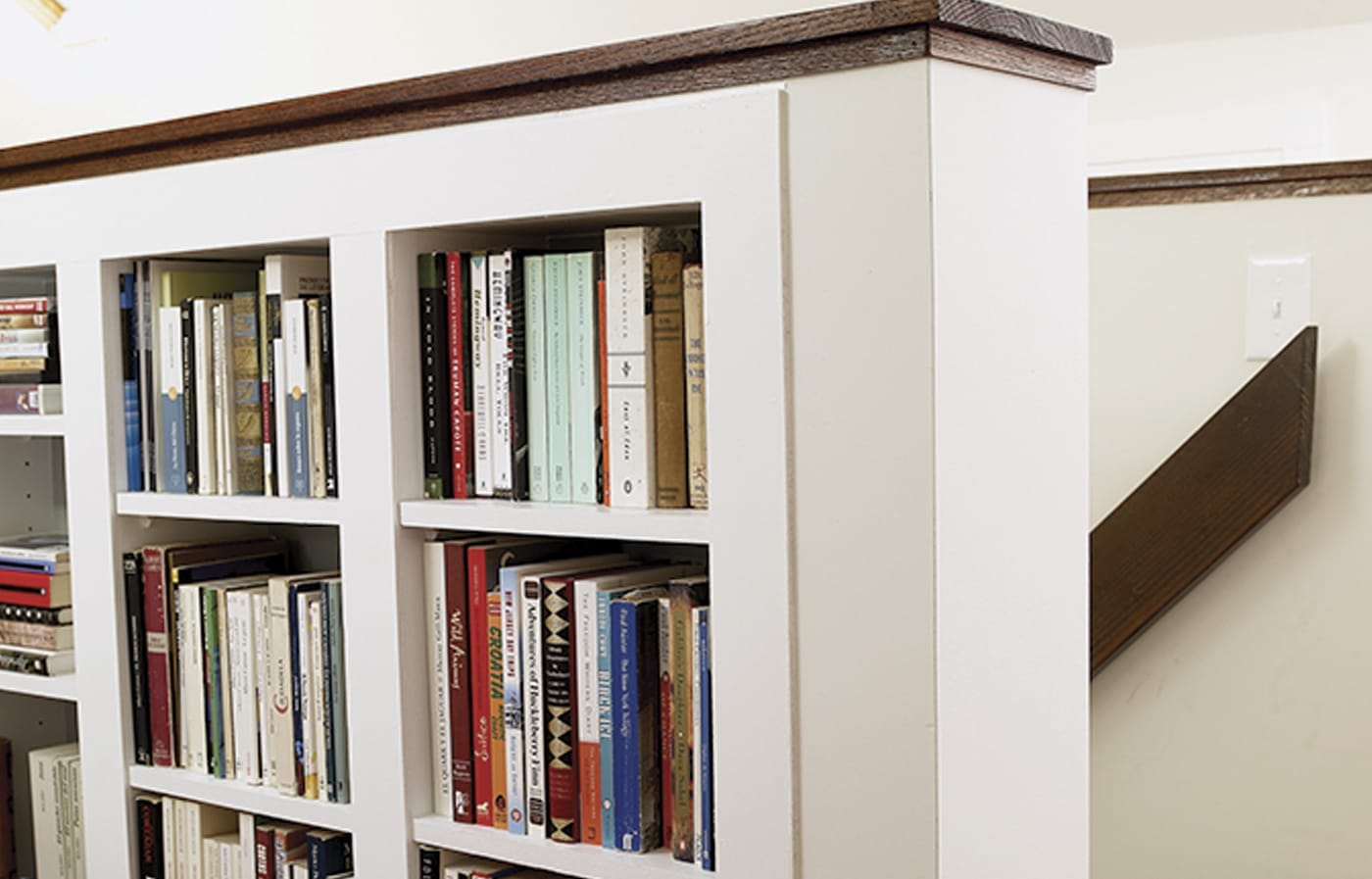 Built-in bookshelves along a staircase wall.