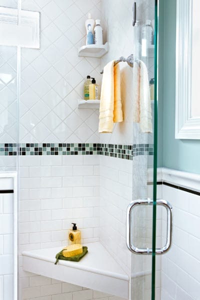 Corner shower seat crafted from white quartz remnant material.