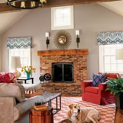 Double-height family room with fireplace surround made from salvaged chimney brick and reclaimed train-whistle factory ceiling timbers.