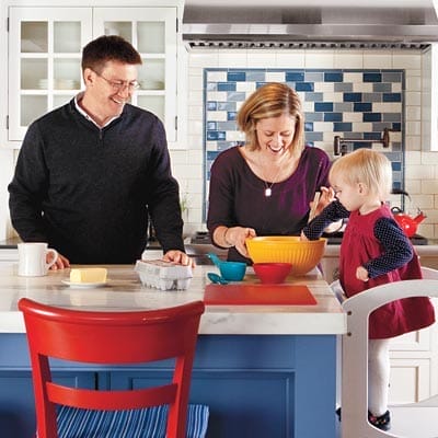 Homeowners and their daughter in their kitchen.