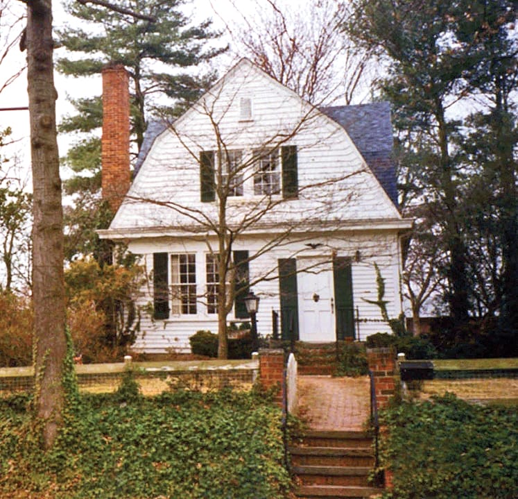 Blue and white Dutch Colonial Revival home with modern paint scheme.