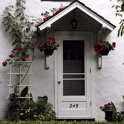 Image of an entryway surrounded by roses