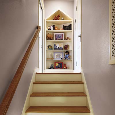 A staircase with a built-in bookcase at the top