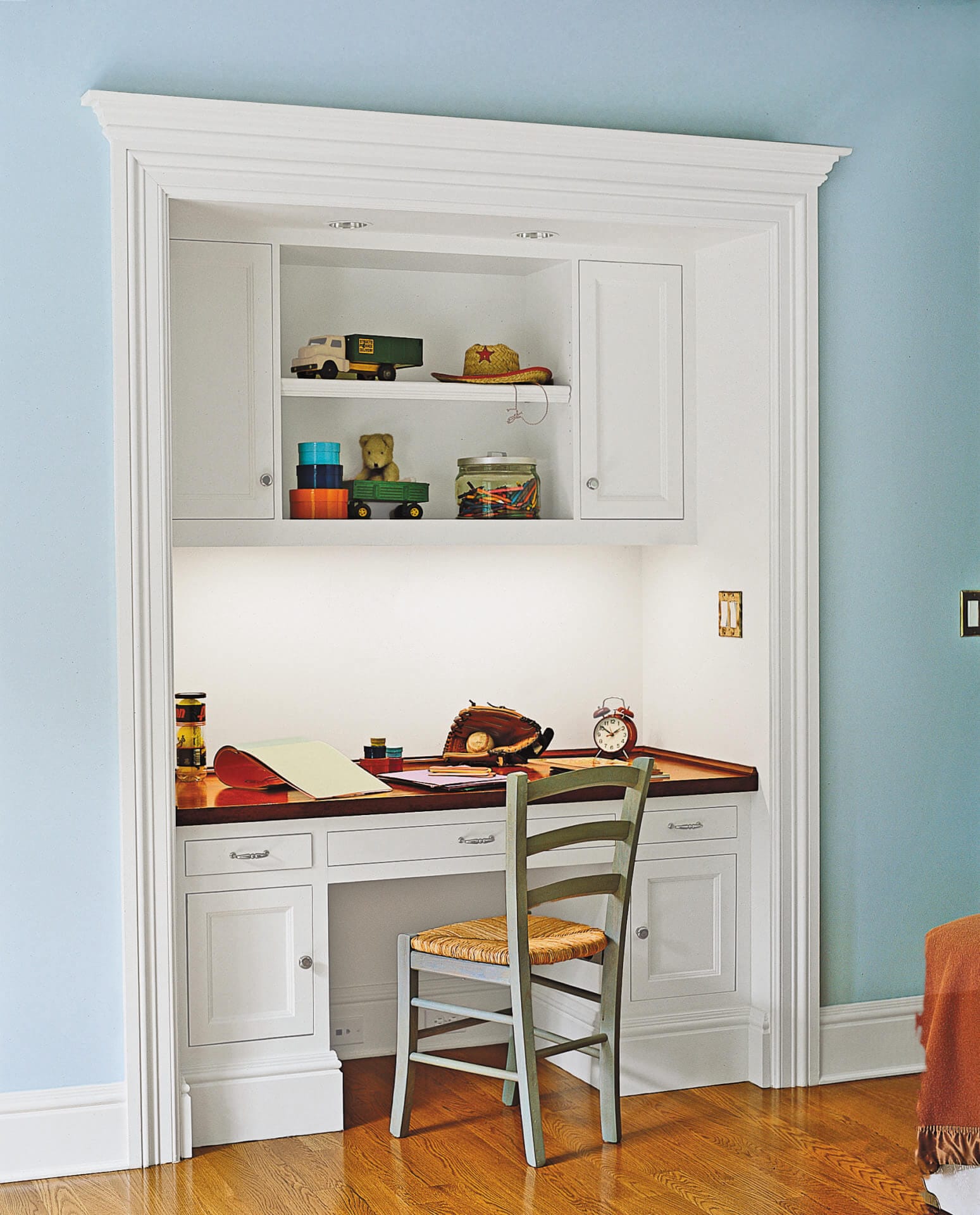 An alcove above a desk for storing items.