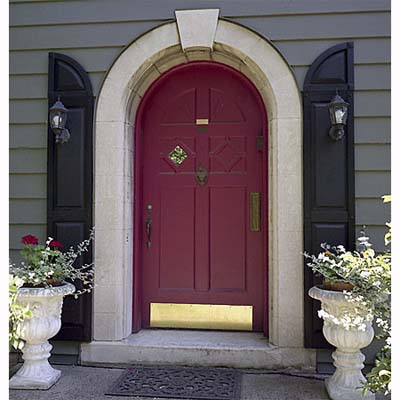 Image of an entryway with arched shutters