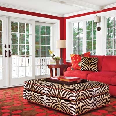 Chocolate brown and red living room featuring rich warm tones and graphic styling.