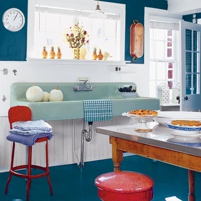 Marine blue walls and floors with celadon and red dramatic color palette.