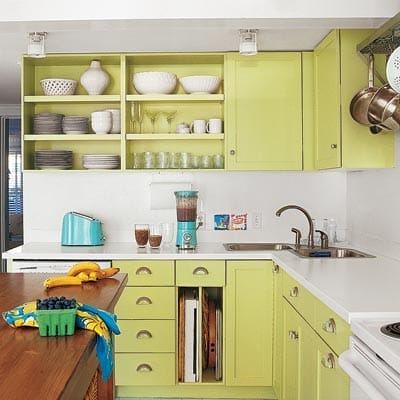 Tangy green yellow cabinetry with minimalist white countertops and backsplash.