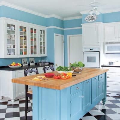 Bright sky blue walls with cloud-white cabinetry and trim details.