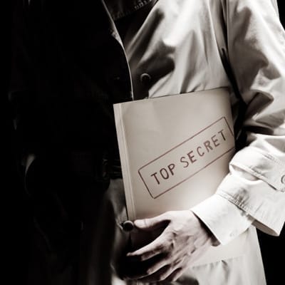 A man holding a top secret manila envelope.