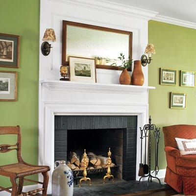 Fresh green painted living room with white trim and natural wood accents.