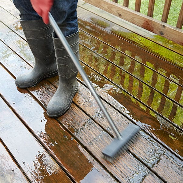 scrubbing a deck to maintain its look and care