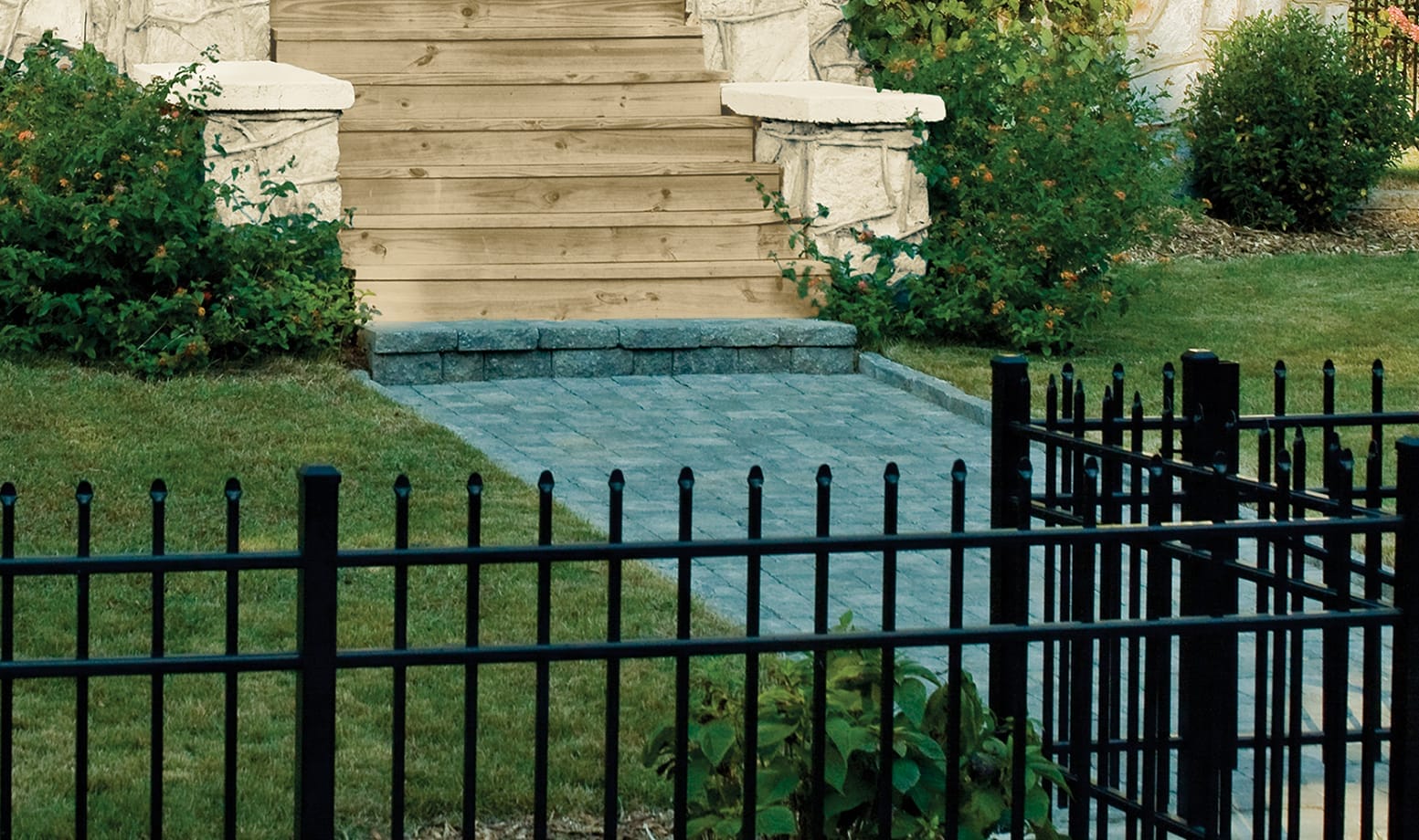 Black aluminum fence with decorative spear-top pickets.