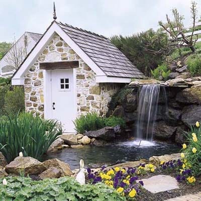 A pond with a storage room beside it.