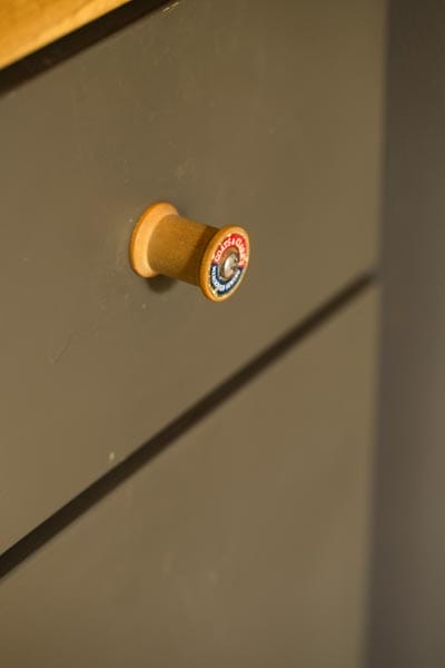 A close-up on thread spool drawer pulls