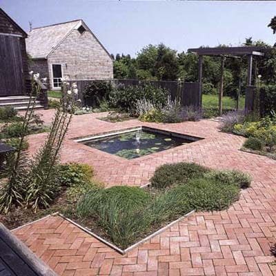 A formal pool pond behind a home.
