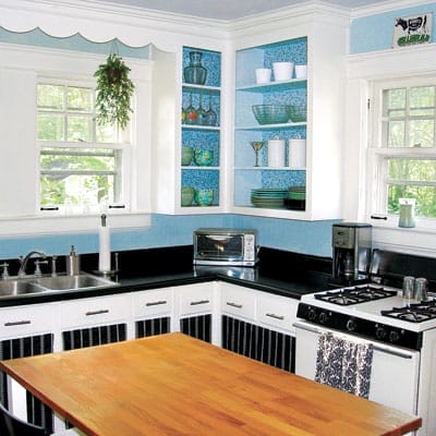 Bright blue and white kitchen makeover with painted counters and fabric cabinet panels.