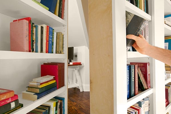 A bookcase that opens to an office space