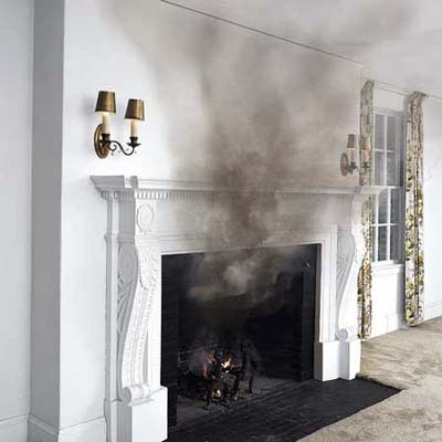 A fireplace with excessive smoke coming out