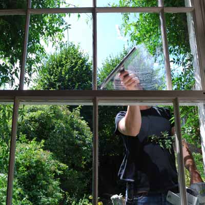 using a squeegee to clean the exterior of windows