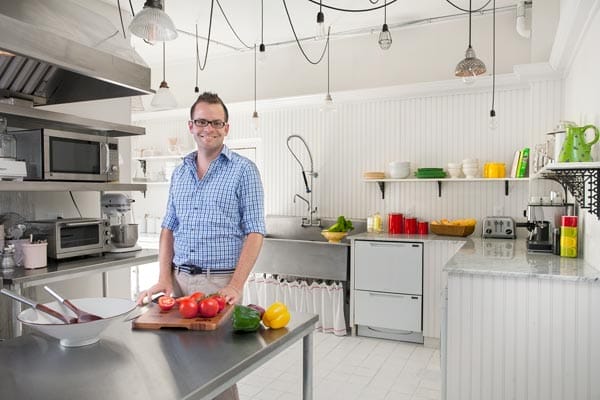 A man standing in the modern kitchen