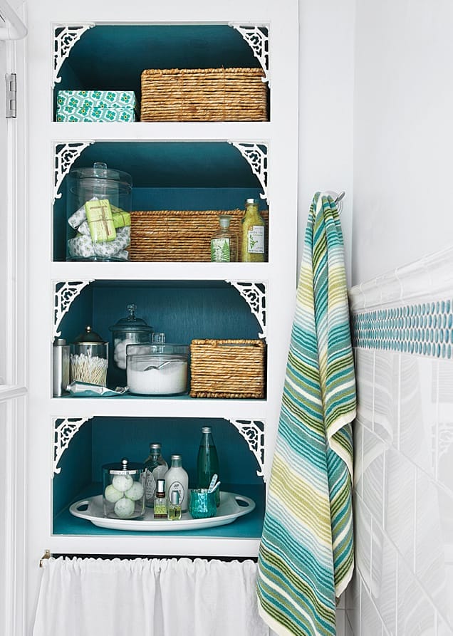 Open shelves with blue paint in the bathroom.