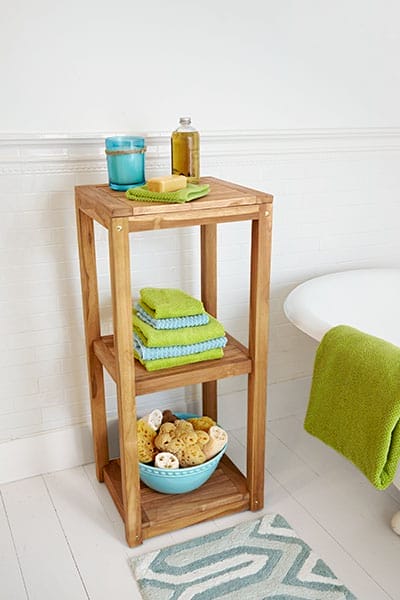 A three-level wooden bathroom organizer.