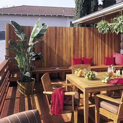 a deck that has privacy seating with a wall
