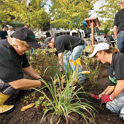 Several people working on a rain garden.