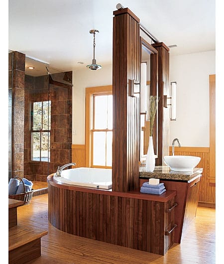 Island-style master bathroom with central vanity and tub.