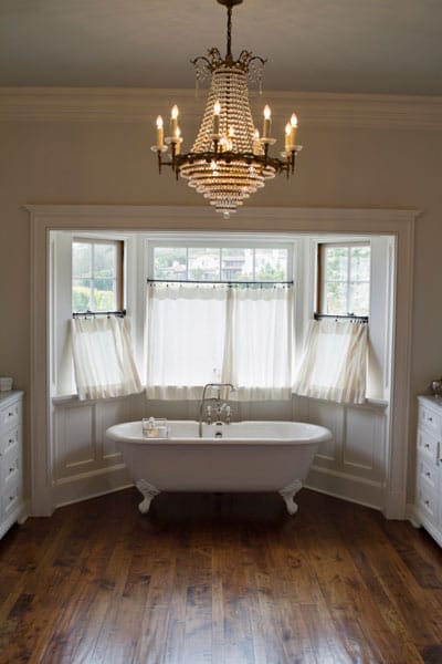 Bathroom chandelier hanging over a bathtub.