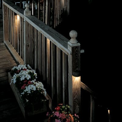 A deck illuminated by small lights.