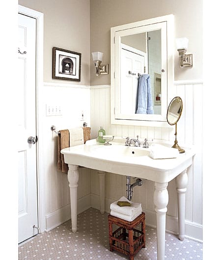 Classic bathroom with console sink and tile flooring.