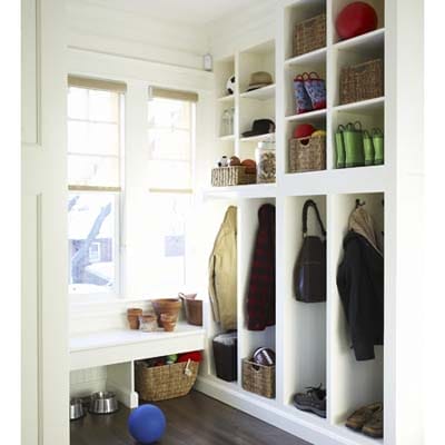 Mudroom with built-in cubbies for coats and shoes, door to porch.