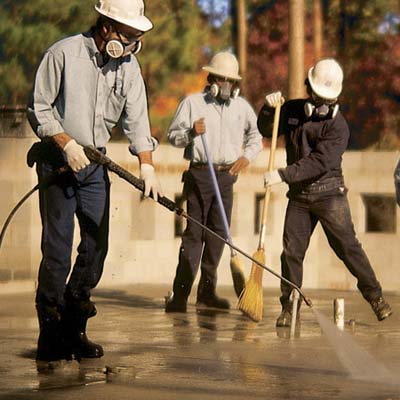 Photo of three workers prepping the subfloor before installing the terrazzo floor. 