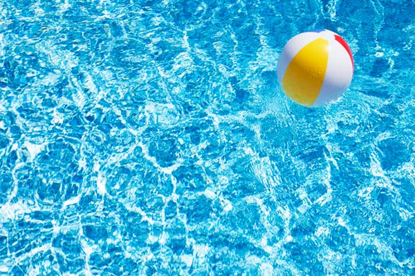 a bright pool with a beach ball