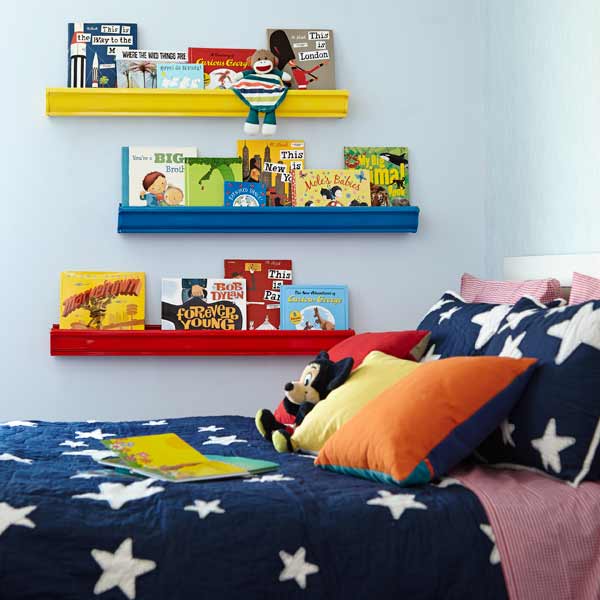 gutters that have been painted and made into floating shelves in a kids room