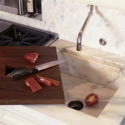 A cutting board on top of a sink