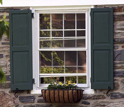 A window box with flowers planted in it.