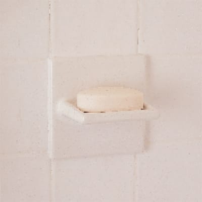 A bathroom upgraded with a new soap dish.