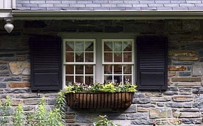 A window box with flowers planted in it.