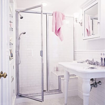A bathroom upgraded by installing a shower door.