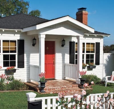 An after photo of the house with a red front door