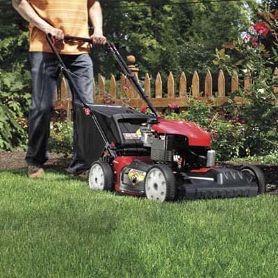 Man mowing green grass.