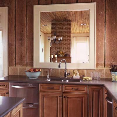 Kitchen with pass-through window, exposed wood walls, and white cabinets.