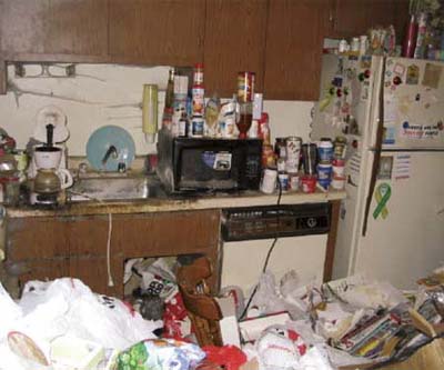 Extremely messy and cluttered kitchen.